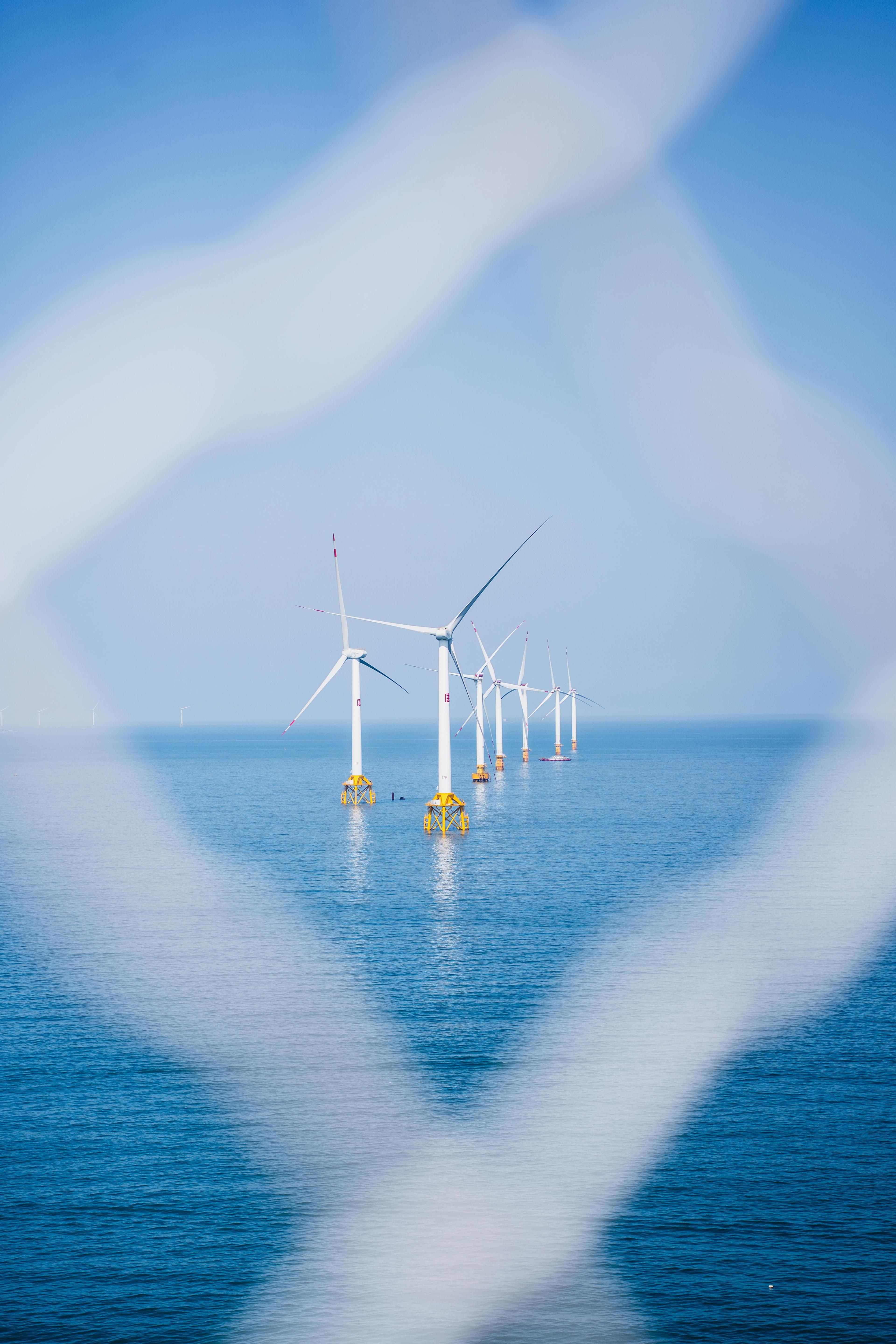 Offshore wind turbines standing in open water.